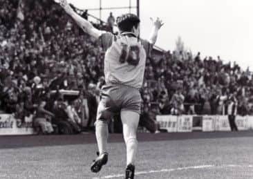 Ian Stringfellow wheels away in front of the old West Stand terracing against Rochdale in 1991-92.