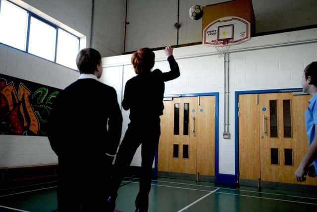 Pupils play basketball in the sports hall at Oakdale.