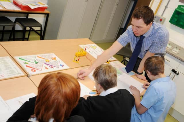 Science teacher Marc Hughes helps Oakdale pupils during a lesson.