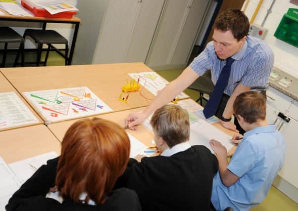Science teacher Marc Hughes helps Oakdale pupils during a lesson.