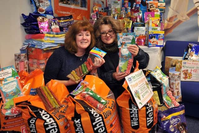 Presentation of pet food to the RSPCA donated by staff and customers of Co-op Travel, pictured are from left fundraiser Wendy Mclaren and RSPCA representative Shelley James (NHUD-21-01-14 RA 1a)