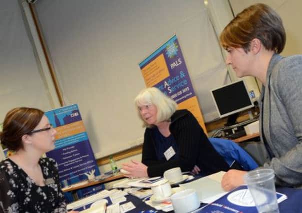 Ashfield Voluntary Action manager, Janet Richards, centre, chats to Kim Pears, left, from the John Godber Centre and Coun. Alice Grice at a Funding Fair held at the Arrow Centre on Wednesday.