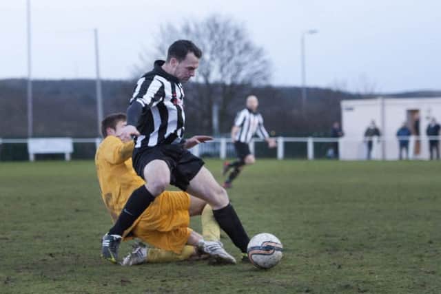Clipsone FC (black/white) v Grimsby Borough (yellow) in the Toolstation Northern Counties East Football League. Result 2-1