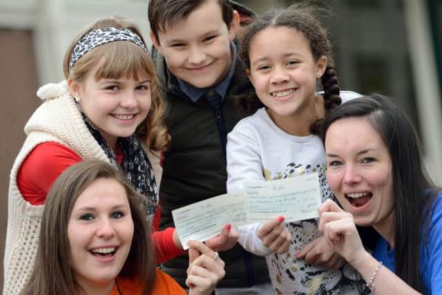 Broomhill Junior School pupils hand over cheques to London Marathon runners Chantal Duarte, left and Lauren Mellor, to go towards their fundraising efforts for Childhood First and the British Lung Foundation.  Pictured are Sophie Tyas, Kyle Kendrick and Liberty Wallace.