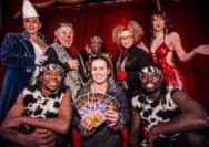 Foodbank Fantasia Circus TicketsRebecca Savage (centre with tickets) surrounded by performers from Fantasia Circus
