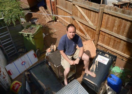 Southwell flood.Landlord Jim Burley sits amongst the debris at the back of the Bramley Apple which was seriously damaged by flood waters.