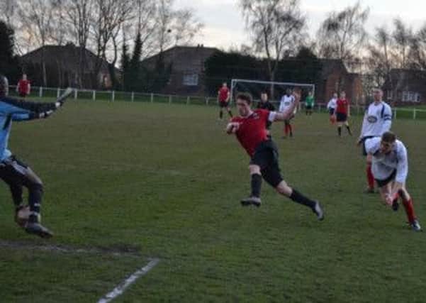 Aaron Moxam fires home Shirebrook's winner. Pic by Pete Waby.