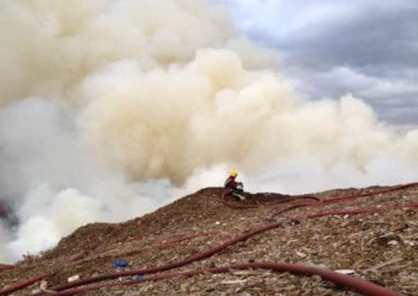 A firefighter tackles the blaze at Arcwood Recycling