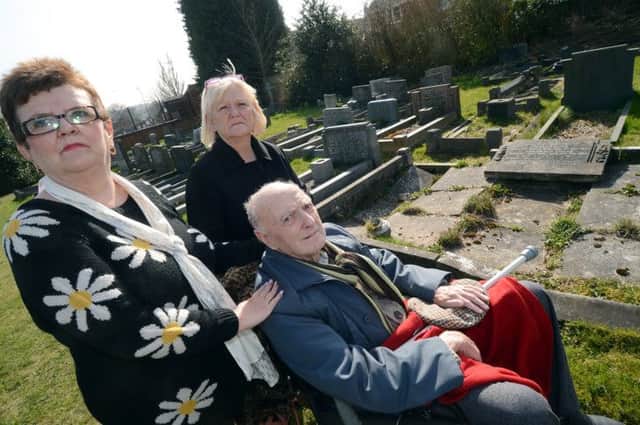 Dennis Ratcliffe, with his daugthers Glenda Smith and Janine Cooper take a walk around a run-down looking graveyard in Forest Town.