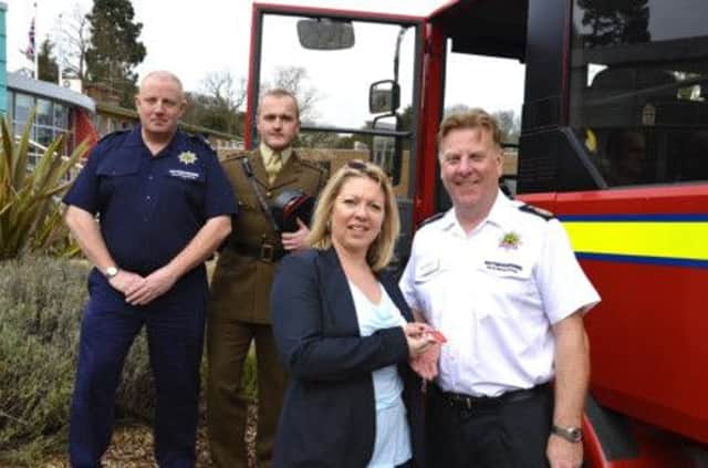Sue Dye from Asset Advantage handing the keys to Chief Fire Officer Frank Swann, watched by Watch Manager Kevin Ruane and Captain Jonathan Slegg