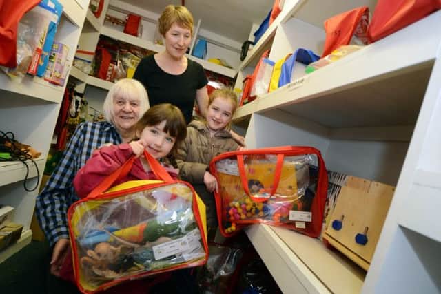 Ashfield Play Forum 30th anniversary.
Volunteer, Pearl Jeffs, left, and toy library worker Linda Binnell help Lucy and Amelia Corbett choose their toys.