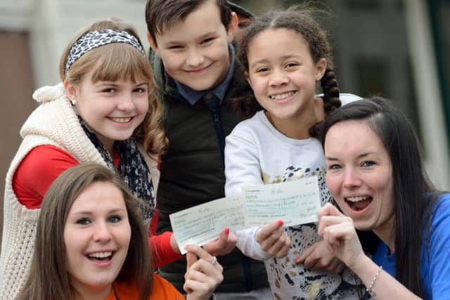 Broomhill Junior School pupils hand over cheques to London Marathon runners Chantal Duarte, left and Lauren Mellor, to go towards their fundraising efforts for Childhood First and the British Lung Foundation. Pictured are Sophie Tyas, Kyle Kendrick and Liberty Wallace.