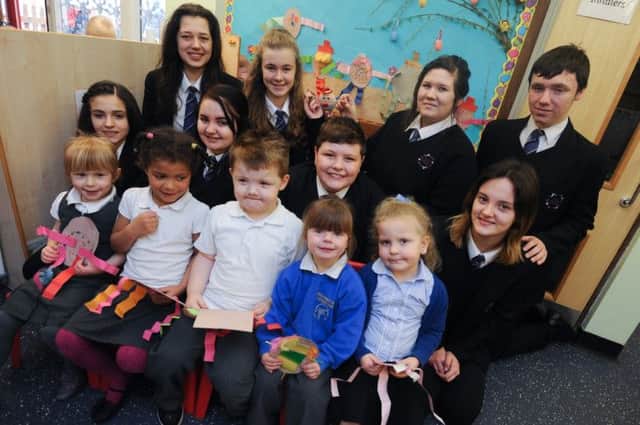 Year 8 and 10 students from Sutton Community Academy visit foundation 1 children at Brierly Forest Primary School to help them with an easter art project. front row children l-r are Ava, Lucy, Alex, Lacey and Kendra.