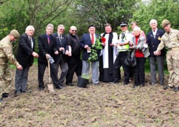 Members of the local clergy, council, RBL, and the armed services scattered poppy seeds.