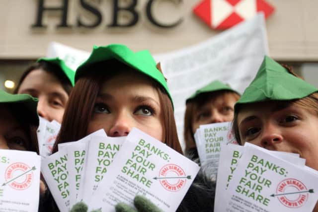 Charity campaigners dressed as Robin Hood who today demanded UK banks pay a £20 billion tax back to society.