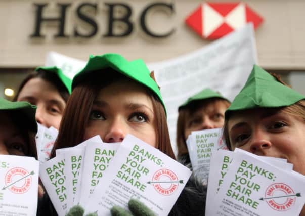 Charity campaigners dressed as Robin Hood who today demanded UK banks pay a £20 billion tax back to society.