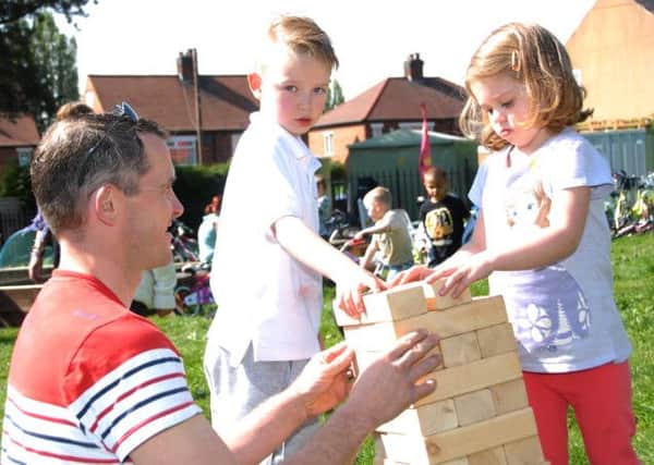 NHUD-Bulwell Forest Garden Open Day on Saturday
Darren Wheelerlow, left helps his daughter Ella and Harrison Dennis to build a wood brick tower