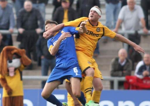 Newport's Lee Minshull is sent off for this challenge on Mansfield's Martin Riley  -Pic by:Richard Parkes