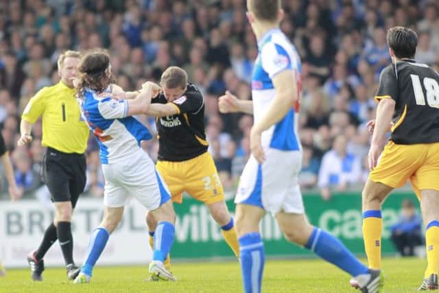 Jamie McGuire has a set to with Rovers John Joe O'Toole under the watchful eye of the referee-Pic by: Richard Parkes