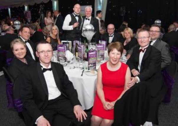 Malcolm Hall, of Hall-Fast Industrial Supplies, with Duncan McKenzie and guests at the charity ball