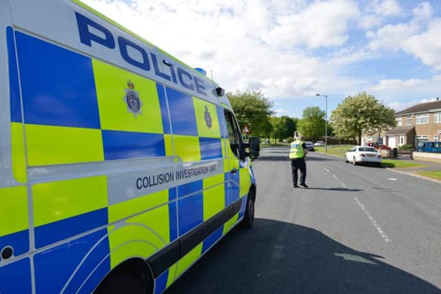 The scene of an incident on the corner of Catcote Road and Stowmarket Close in Fens, where a car being chased by the police collided with a tree. Police officers from the collision investigation unit record the scene.