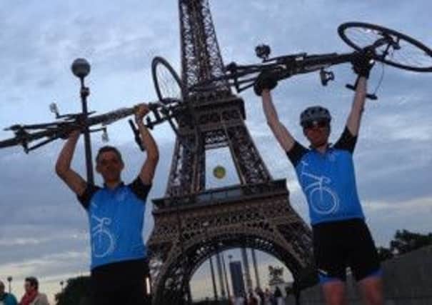 Richard Candlin and Richard Eldridge, raising money for Parkinson's UK, celebrate reaching the Eiffel Tower in Paris.
