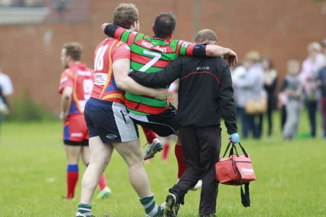 Scott Thacker is taken off the pitch through a leg injury in the very first minute of the game -Pic by: Richard Parkes