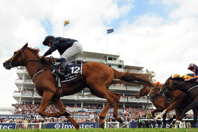 WORLD BEATER -- Aidan O'Brien's Ruler Of The World flashes past the post to win last year's Investec Derby at Epsom (PHOTO BY: Andrew Matthews/PA Wire).