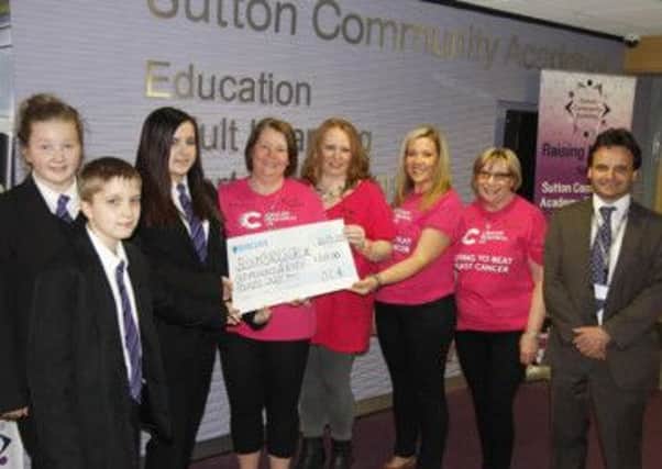 Sutton Community Academy students Ben Haywood, Courtney Williams and Jade Chamberlain with representatives from Bosom Babes CRUK (Cancer Research UK) and Simon Martin, principal.
