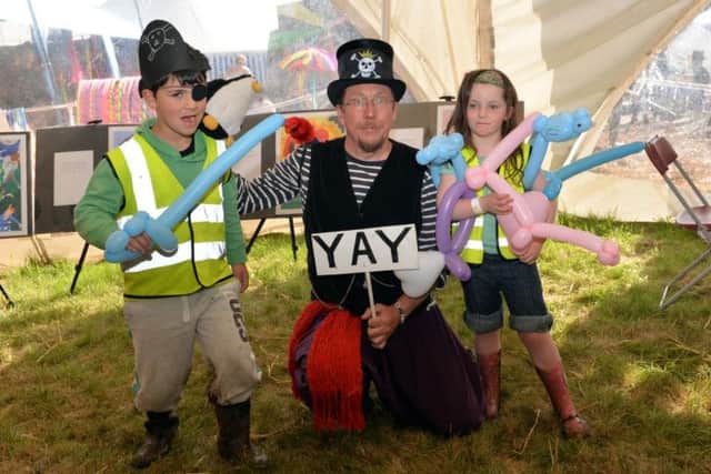 Southwell Folk Festival, entertainment for all the family. Thibault Vincent, six and Carla Vincent, four meet Mark Fraser