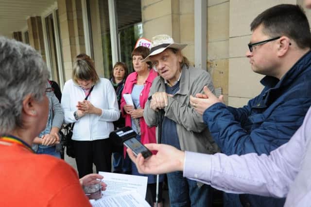 Protesters held a rally outside County Hall over the cuts.