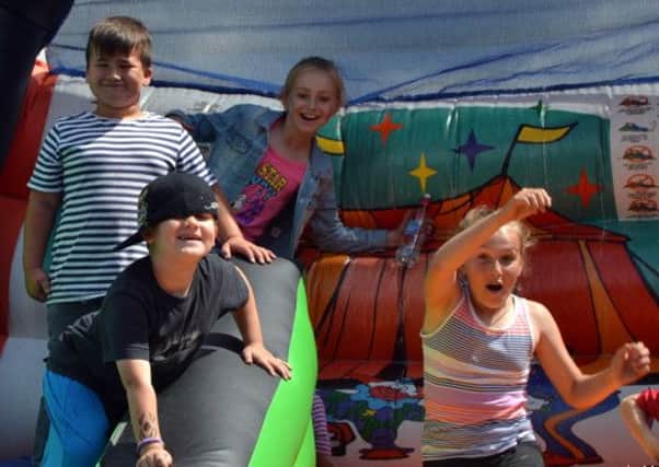 Thumbs up: Youngsters having fun at Shirebrook Model Village's Summer Fayre at the weekend.