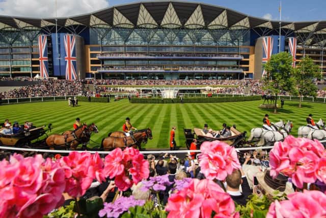 FIT FOR A QUEEN -- the scene at spectacular Royal Ascot as the royal procession arrives for the final day. (PHOTO BY: Dominic Lipinski/PA Wire)