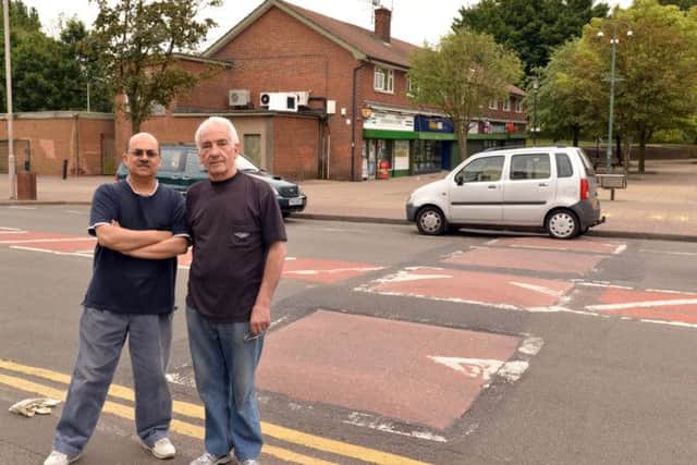 Shop owners Terry Cook and Kalpesh Bhatt are among those who want the speed bumps on Ladybrook Lane removing.
