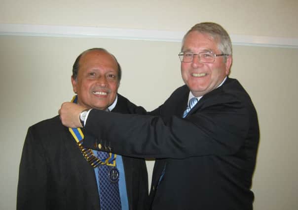 At the Annual Handover meeting of the Rotary Club of West Ashfield 2014, Past President Rtn John Culverhouse presenting the Presidential Badge of Office to the incoming President, Rtn. Dr. Celestine John.