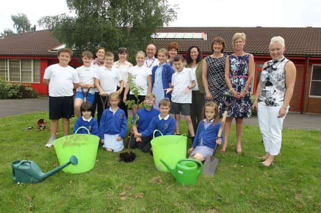 Pupils and staff at Heatherley Prinary School celebrated the schools 25th birthday by planting a tree and a time capsule