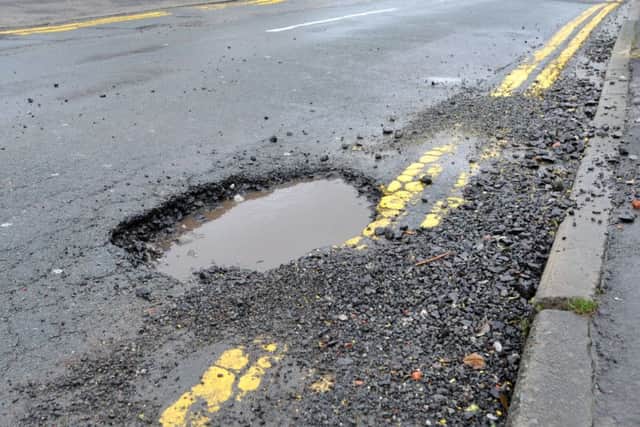 Large potholes causing danger to motorists and cyclists, which have appeared on Wilton Avenue, Whelley, Wigan.