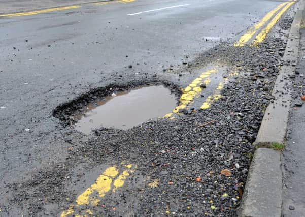 Large potholes causing danger to motorists and cyclists, which have appeared on Wilton Avenue, Whelley, Wigan.