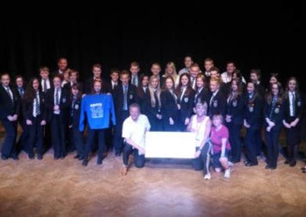 Students and staff who went on Ashfield School's ski trip get presented with their prize by Interski.