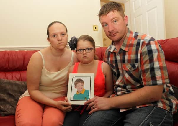 Laura, Stephen, and Chloee Gregory from Kirkby with a photo of Corey who died aged 11 after suffering from a rare condition which affected his immune system.