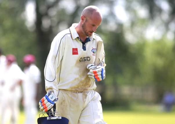 A disappointed Ian Parkin walks back to the pavilion after losing his wicket -Pic by: Richard Parkes
