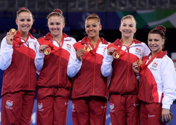 England's (left to right) Hannah Whelan, Ruby Harold, Rebecca Downie, Kelly Simm and Claudia Fragapane celebrate with their gold medals after winning the Women's Artistic Gymnastic's Team Final and Individual Qualificationat the SSE Hydro, during the 2014 Commonwealth Games in Glasgow. PRESS ASSOCIATION Photo. Picture date: Tuesday July 29, 2014. See PA story COMMONWEALTH Athletics. Photo credit should read: Dominic Lipinski/PA Wire. RESTRICTIONS: Editorial use only. No commercial use. No video emulation.