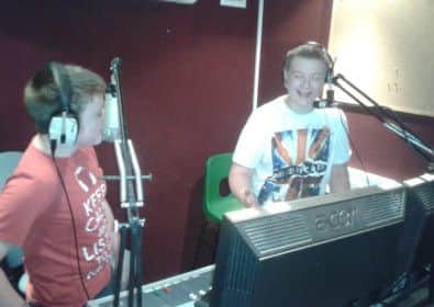 Nathan Tomlinson and Anthony Davies share a joke on air.