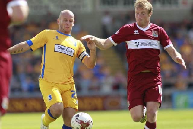 Adam Murray in a midfield duel -Pic by: Richard Parkes