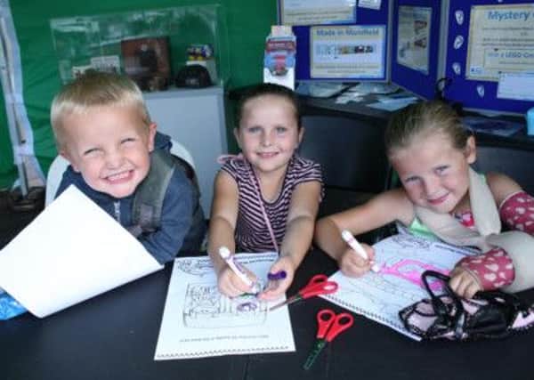 Bethany, Rhianna and Junior enjoy colouring pictures at the mini Mansfield Museum.