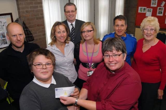 Bringing communities together is a leading aim of Neighbourhood Watch schemes.In this instance, student Paul Laking, from the Oakdale School on Westfield Lane, hands over the proceeds from a summer fun day totalling £360 to the Rev Barbara Greenwood at the Chesterfield Road South Methodist Church last Thursday.  Also pictured are from left, neighbourhood warden Andy Gwynne, leadership team member Mel Loyeau, church leader Keith Bonsall, specialised teaching assistant Donna Overton, PCSO Romek Kordecki and Dorothy Wright from the Titchfield Neighbourhood Watch.