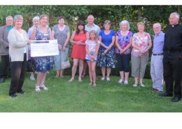 Mansfield's Old Meeting House Unitarian Chapel hand over £1,838 to the John Eastwood Hospice.