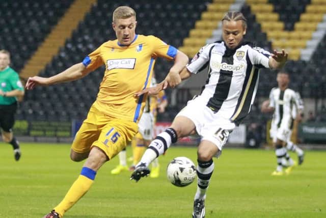 Simon Heslop chases down Notts County's Curtis Thompson -Pic by: Richard Parkes