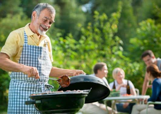 Family having a barbecue party in their garden in summer