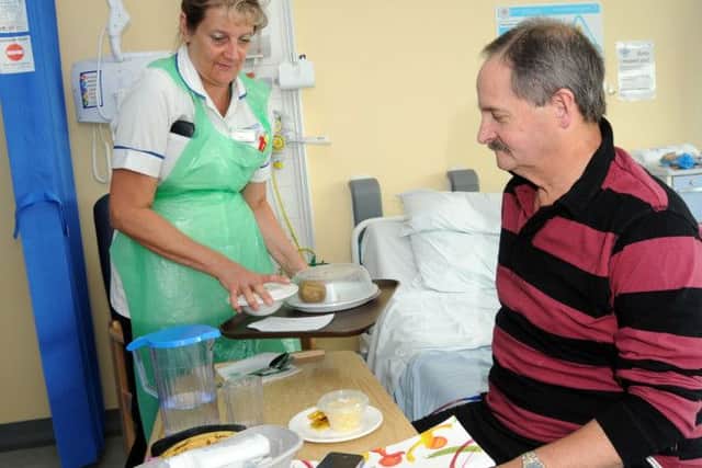 Bob Chaytor from Forest Town is served his mid-day meal by healthcare assistant Lesley Ritchie.